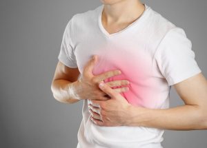 bigstock-A-Man-Holds-The-Breasts-The-P-185589043