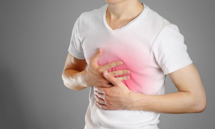 bigstock-A-Man-Holds-The-Breasts-The-P-185589043